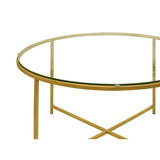 Round Metal Coffee Table With Glass Top and X Shape Base, Gold and Clear